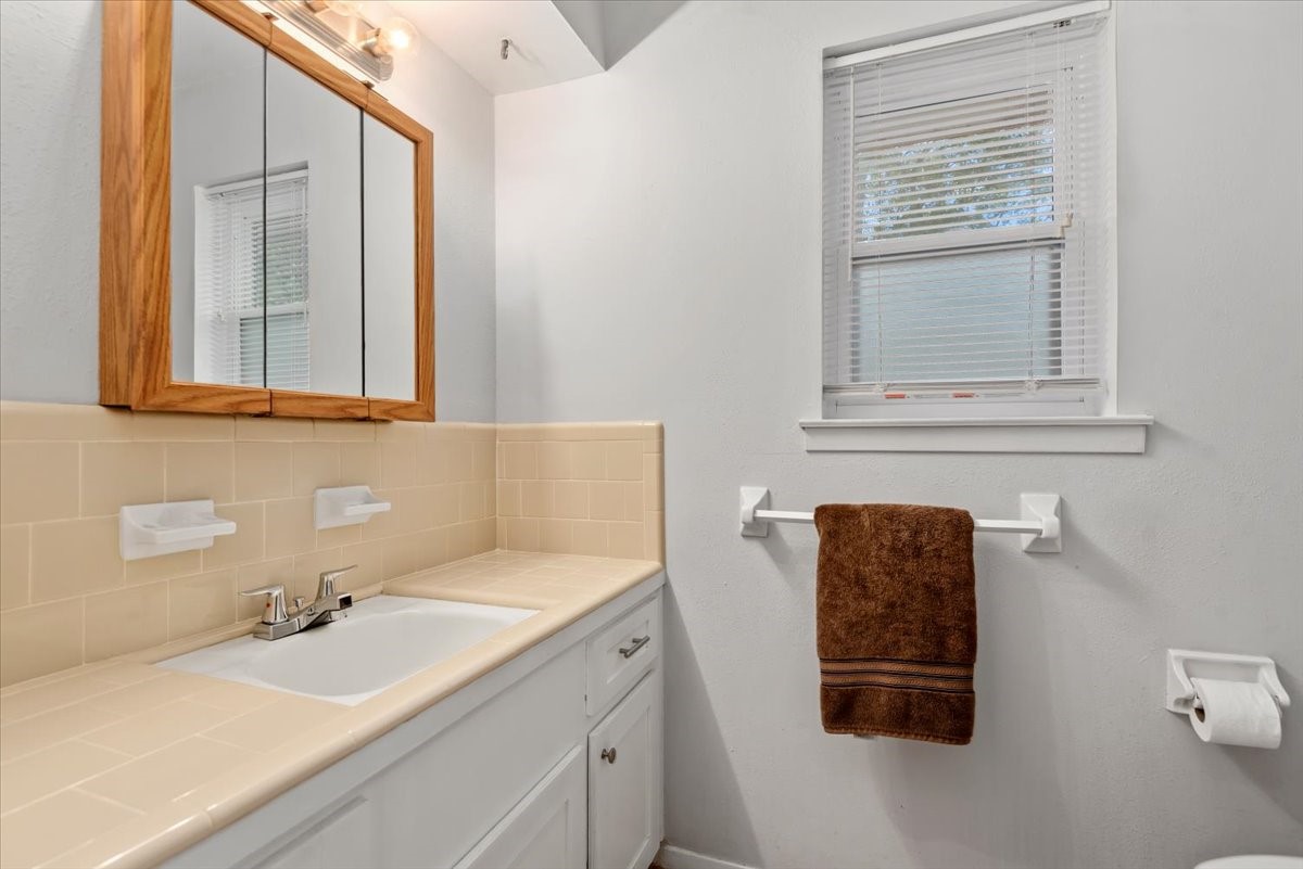 1651 Fultz Court Conroe, TX 77304 - Photo 25 of 38 a bathroom with a sink and a mirror