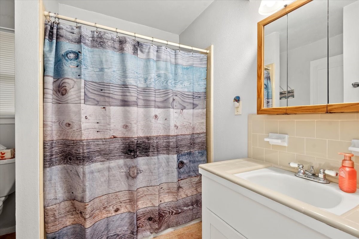 1651 Fultz Court Conroe, TX 77304 - Photo 26 of 38 a bathroom with a sink and a shower