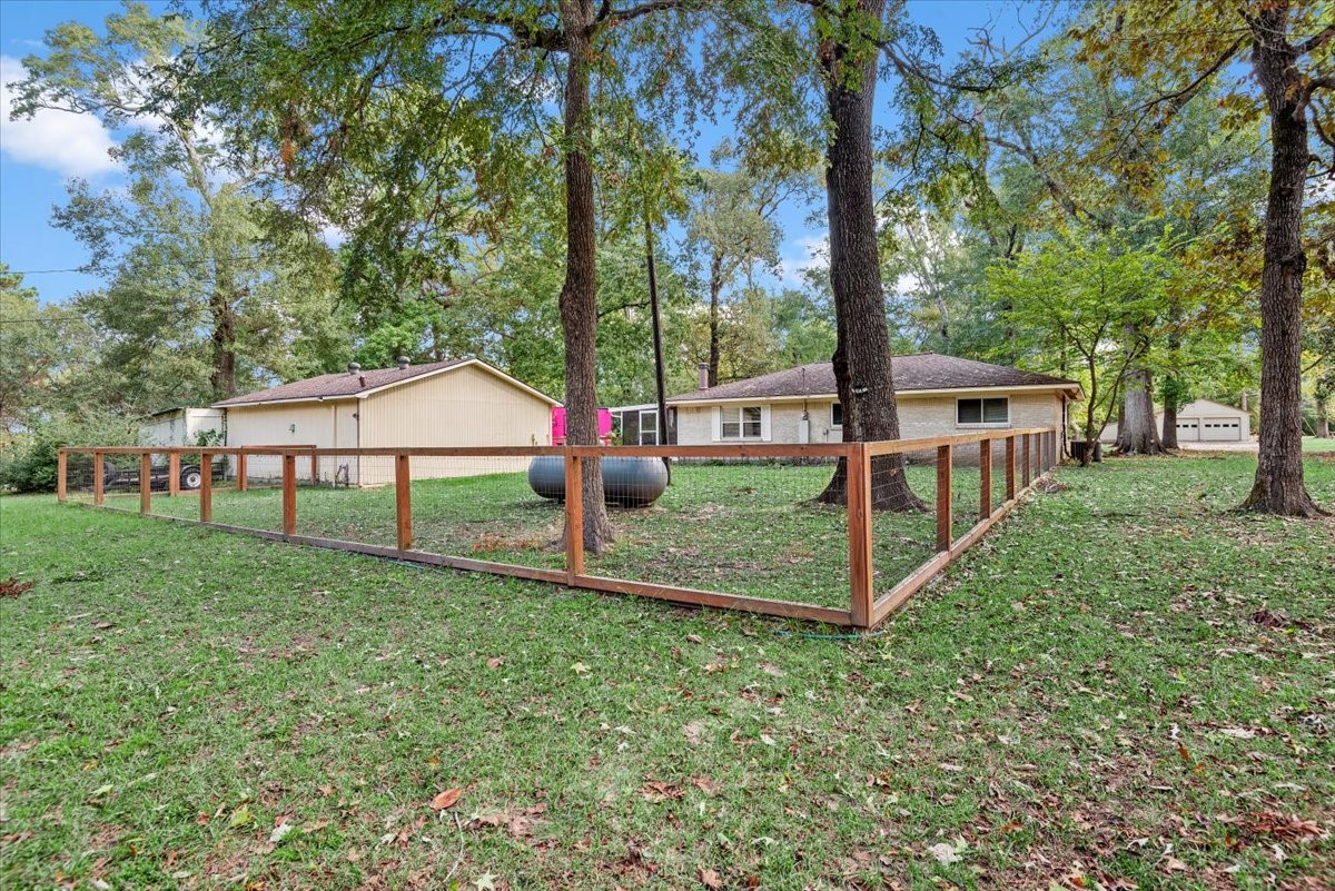 1651 Fultz Court Conroe, TX 77304 - Photo 30 of 38 a view of a house with backyard and sitting area