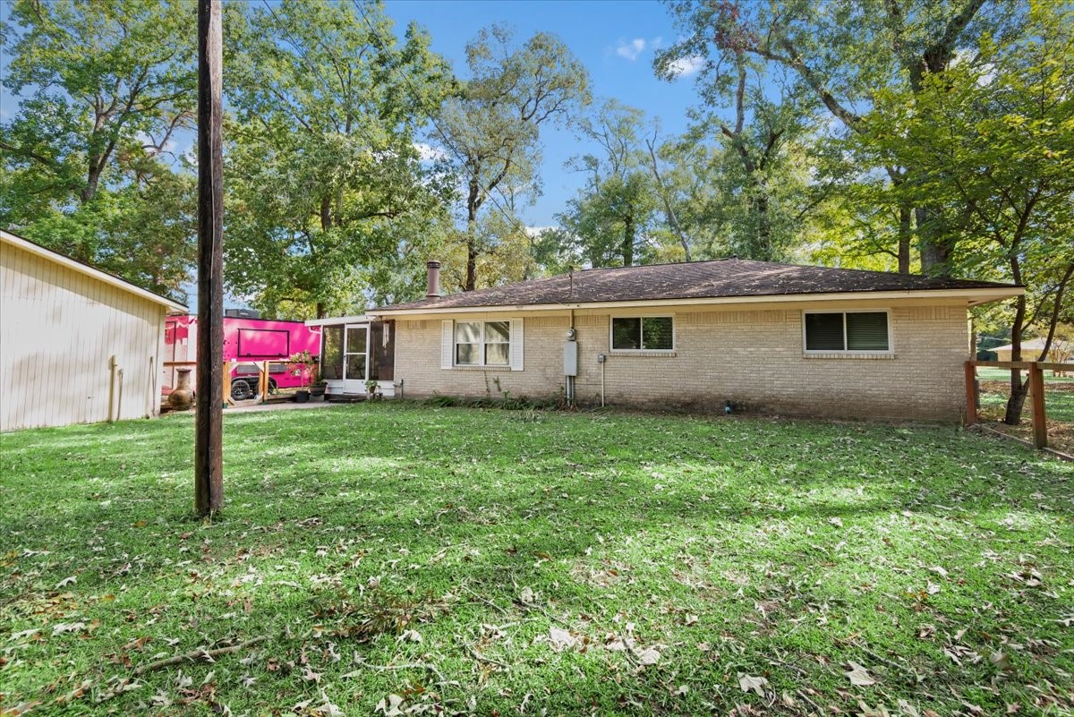 1651 Fultz Court Conroe, TX 77304 - Photo 32 of 38 a view of an house with backyard space and garden