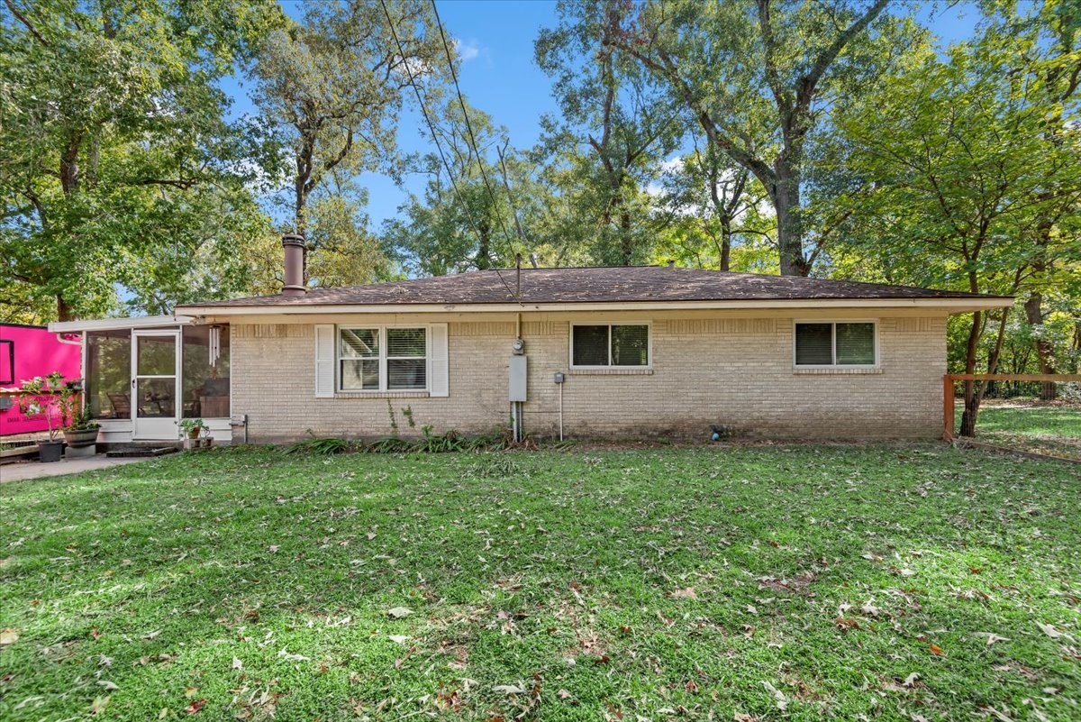 1651 Fultz Court Conroe, TX 77304 - Photo 33 of 38 a backyard of a house with table and chairs