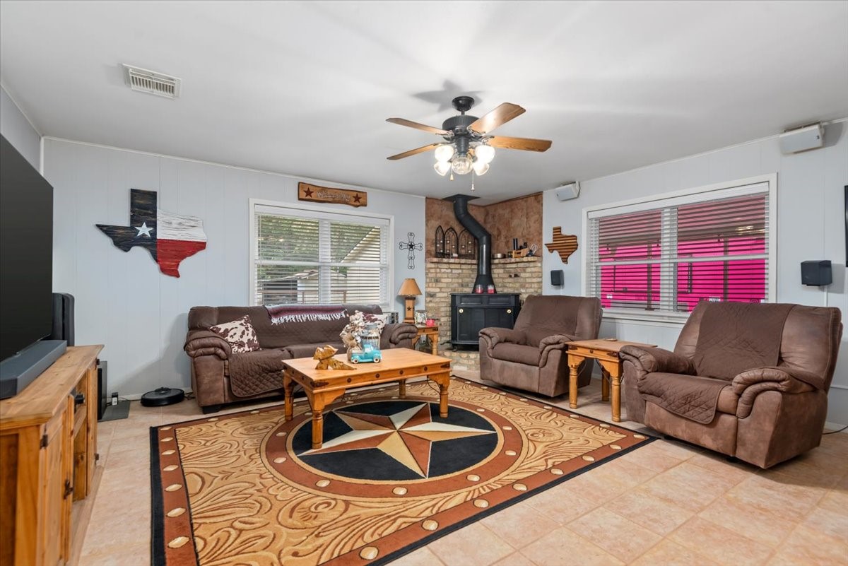 1651 Fultz Court Conroe, TX 77304 - Photo 9 of 38 a living room with furniture a chandelier and a window
