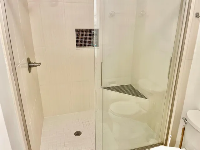 a bathroom with a shower and a sink