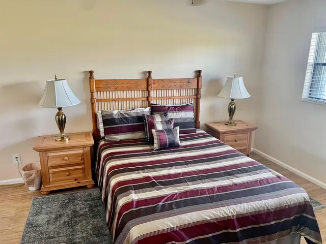 a bedroom with a bed and lamp