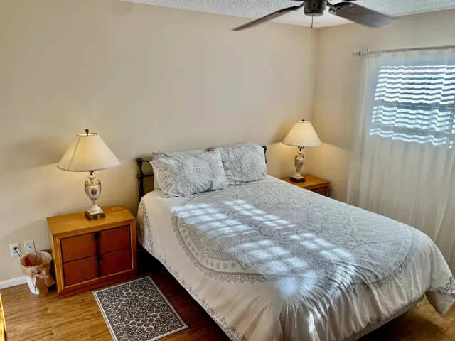 a bedroom with a bed and a lamp