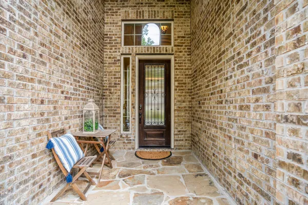a kitchen with a table chairs stove and wooden floor