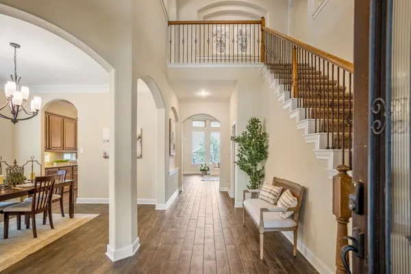 a kitchen with stainless steel appliances granite countertop a sink a stove cabinets and wooden floor