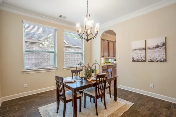 a living room with furniture a fireplace and a chandelier