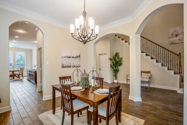 a spacious bathroom with a granite countertop double vanity sink a mirror and a shower