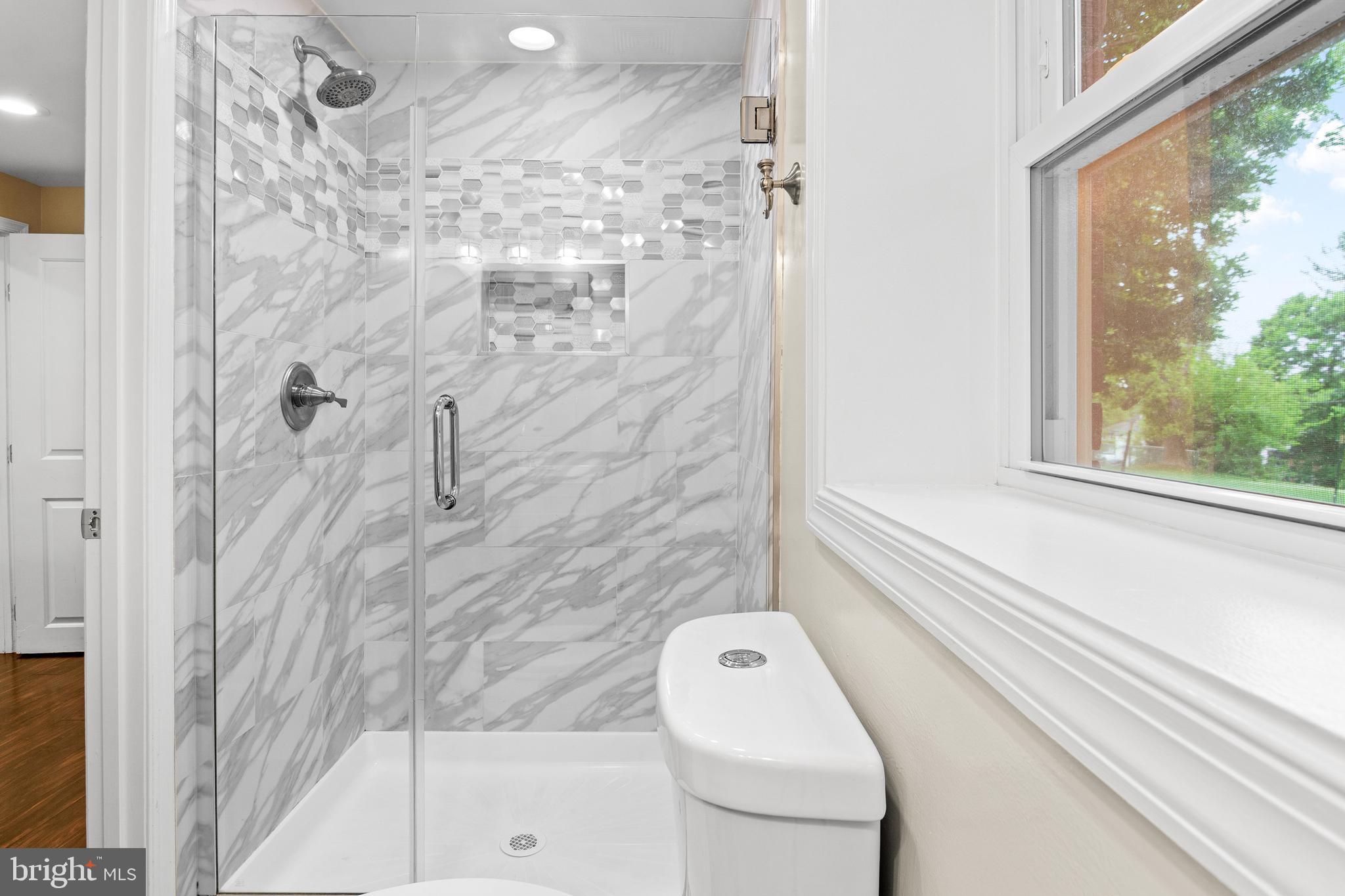6308 Ivymount Road Baltimore, MD 21209 - Photo 18 of 22 a bathroom with a shower a toilet and a shower