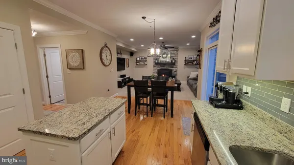 a living room with furniture kitchen and a chandelier