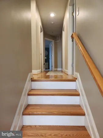 a bedroom with a bed and a flat tv screen on dresser