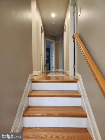 a bedroom with a bed and a flat tv screen on dresser