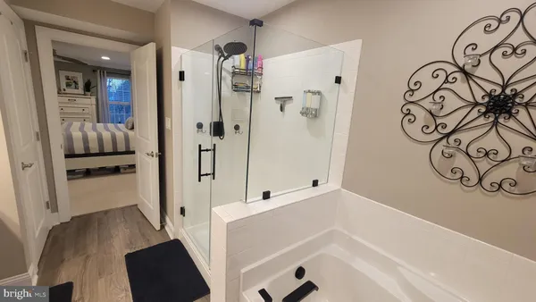 a view of walk in closet with clothes