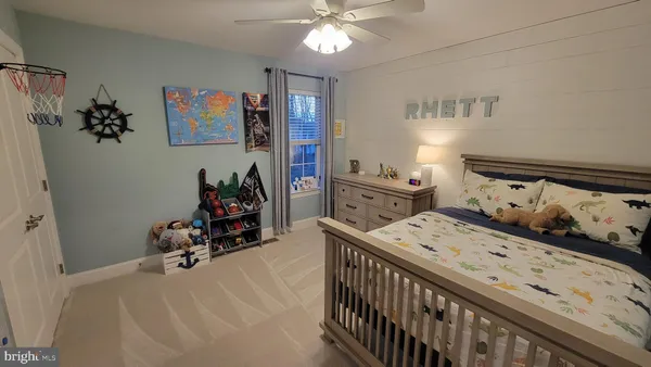a view of a hallway with painting on the wall and a window