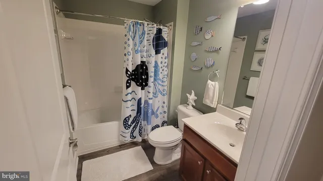a bathroom with a toilet and a mirror