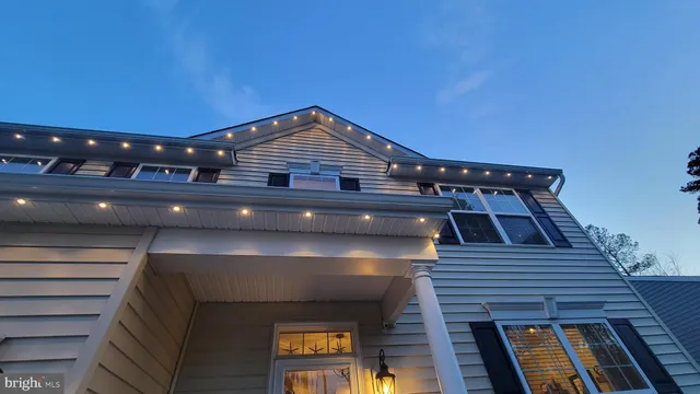 a view of a house with a yard and furniture