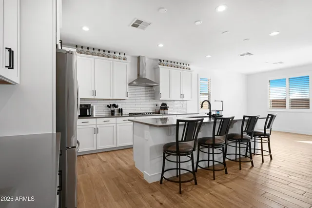 a view of kitchen with cabinets table and chairs