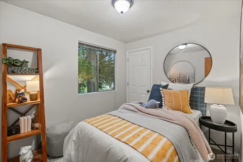 a bedroom with a bed and a painting on the wall