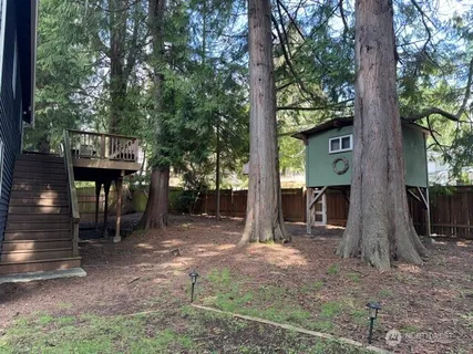 a backyard of a house with seating space and trees