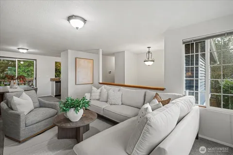 a living room with furniture and a potted plant
