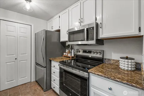 a kitchen with cabinets stainless steel appliances and a sink