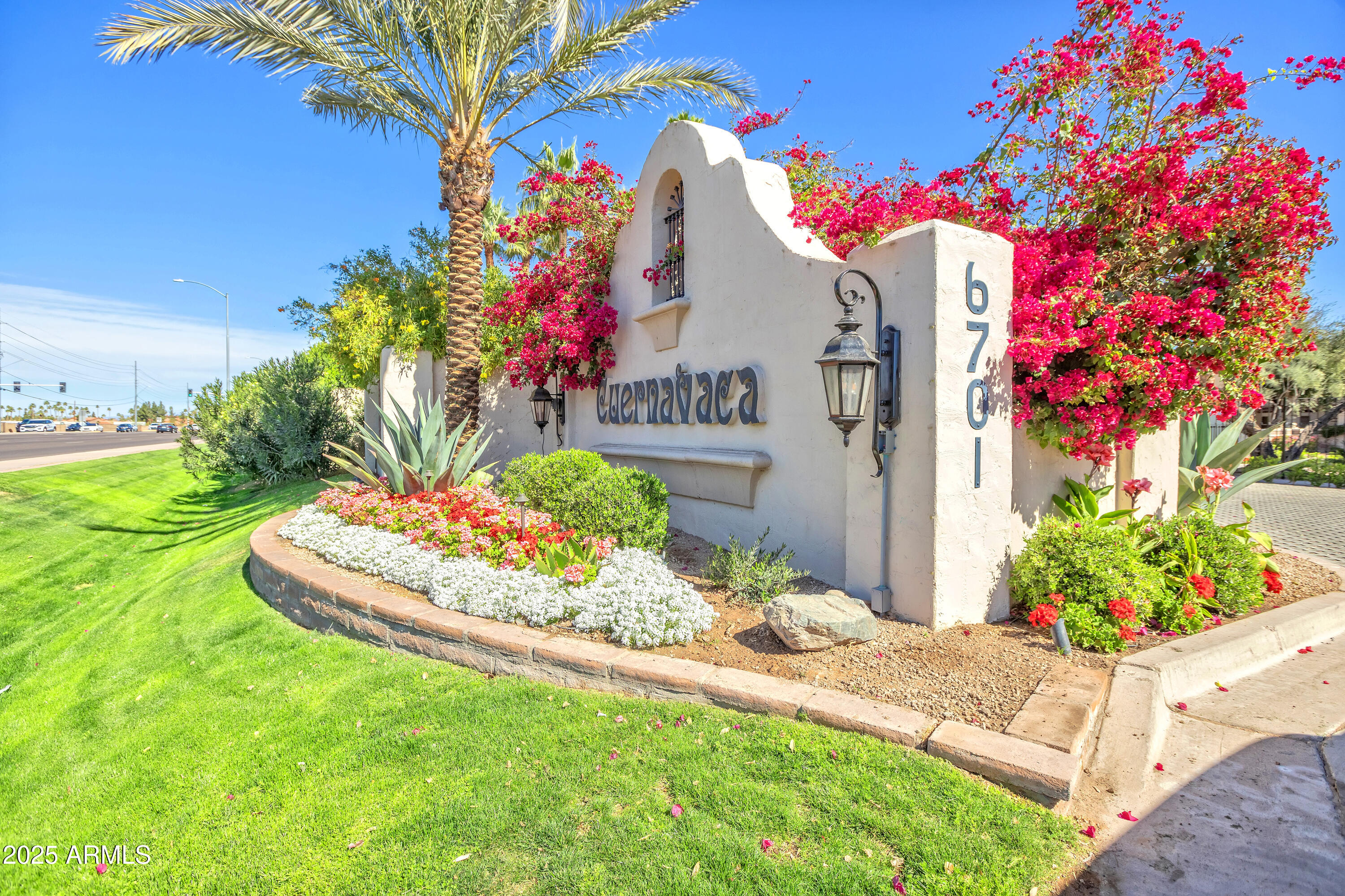 6701 North Scottsdale Road, Unit 23 Scottsdale, AZ 85250 - Photo 1 of 47 a front view of a house with a yard and fountain