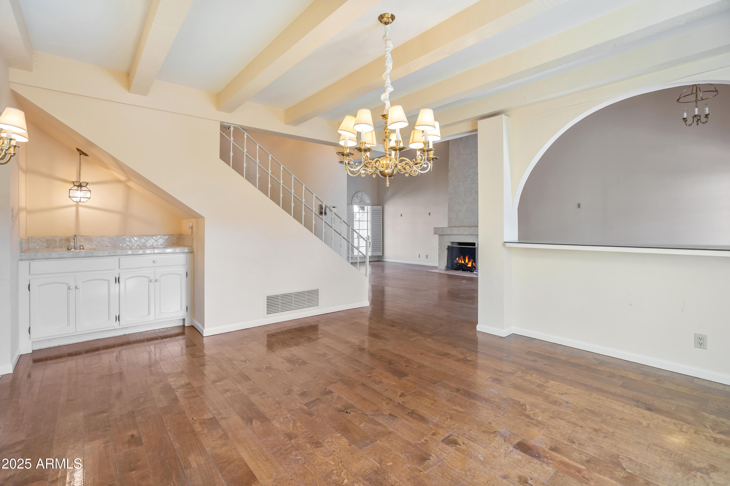 6701 North Scottsdale Road, Unit 23 Scottsdale, AZ 85250 - Photo 15 of 47 a view of a livingroom with wooden floor and staircase