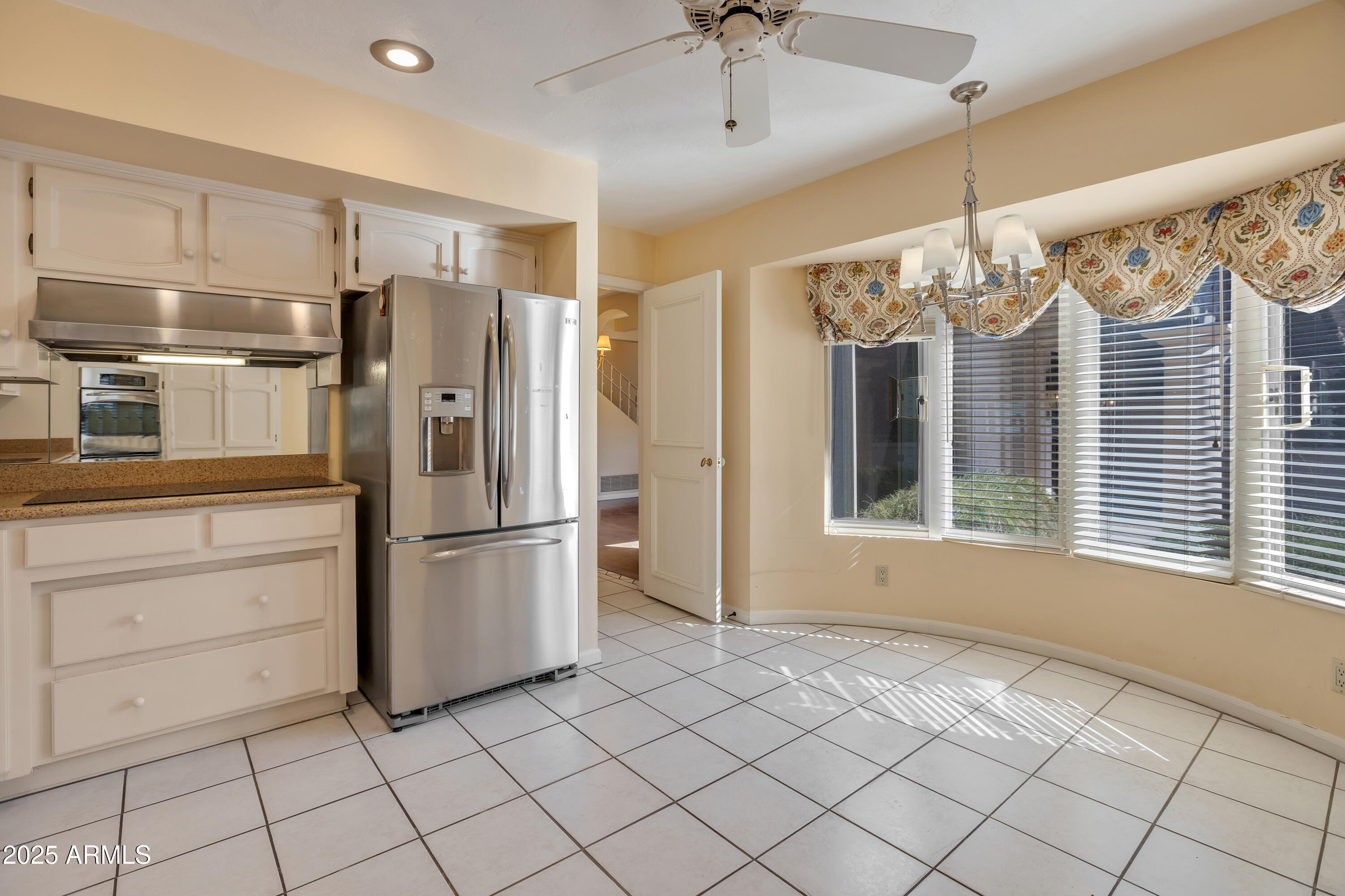 6701 North Scottsdale Road, Unit 23 Scottsdale, AZ 85250 - Photo 21 of 47 a kitchen with windows and refrigerator