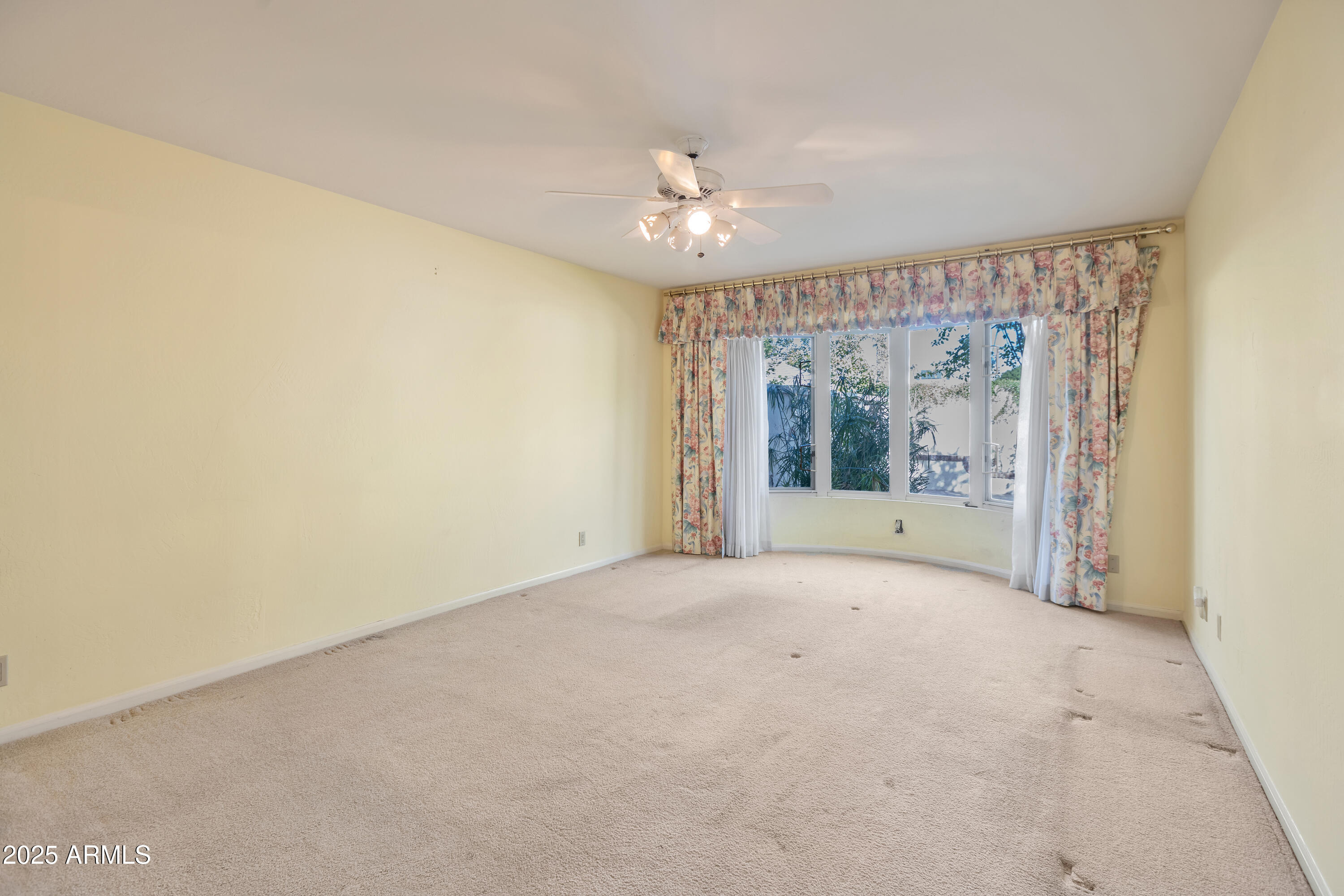 6701 North Scottsdale Road, Unit 23 Scottsdale, AZ 85250 - Photo 26 of 47 a view of an empty room with chandelier fan and a window