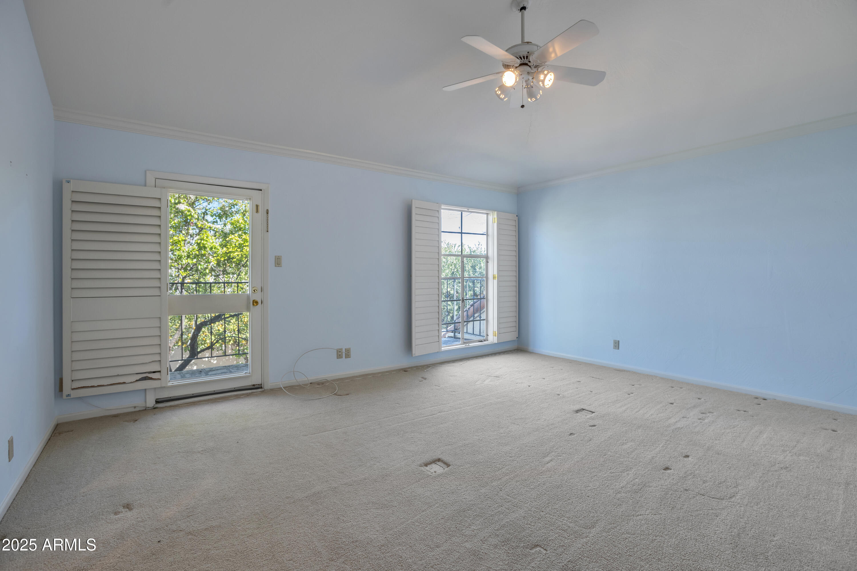 6701 North Scottsdale Road, Unit 23 Scottsdale, AZ 85250 - Photo 29 of 47 an empty room with windows and fan