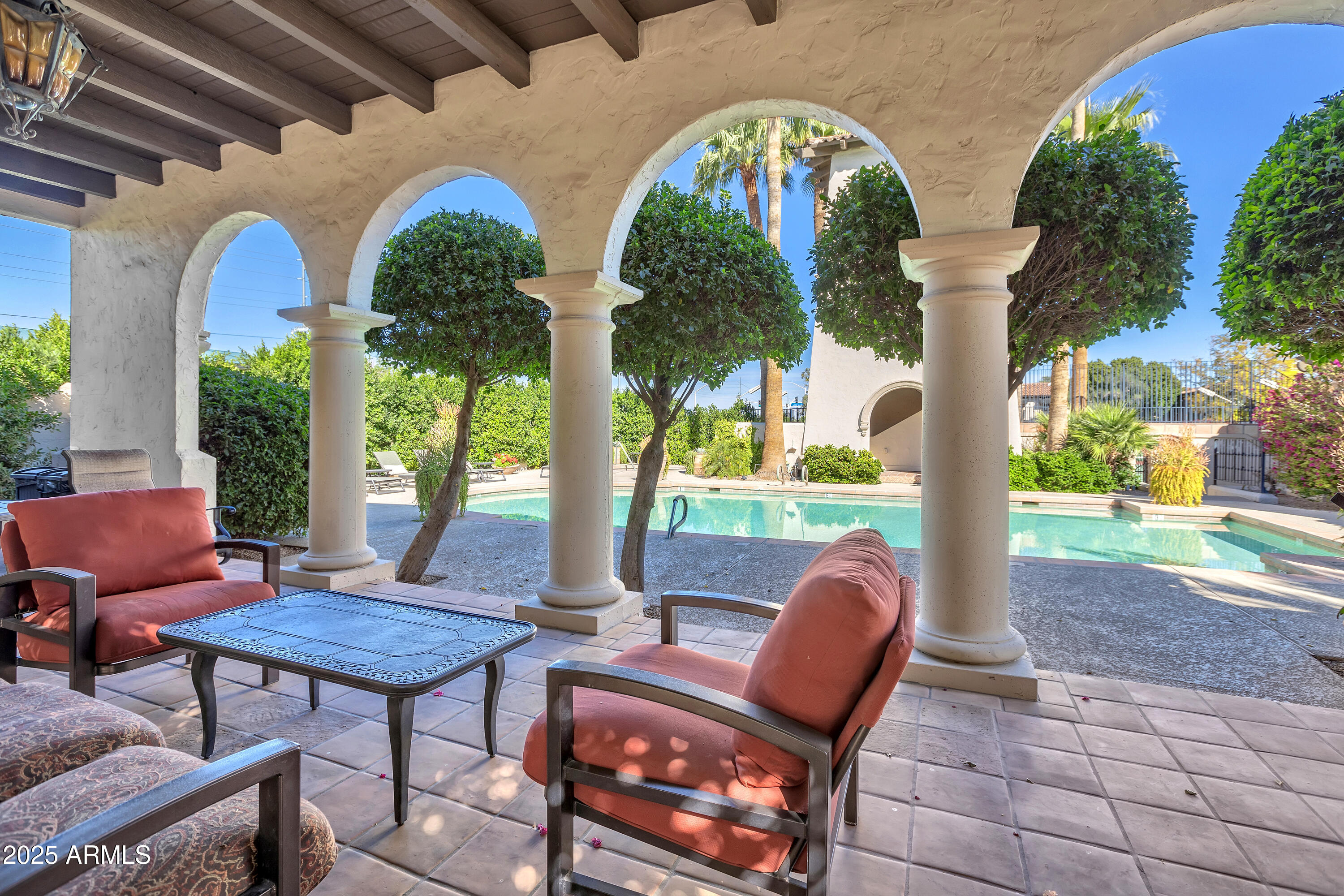 6701 North Scottsdale Road, Unit 23 Scottsdale, AZ 85250 - Photo 39 of 47 a view of a porch with furniture and a yard