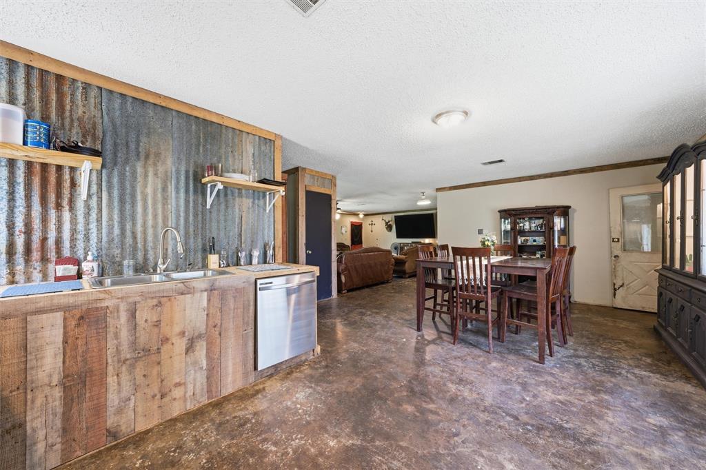 3122 Gun Club Road Temple, TX 76501 - Photo 7 of 22 a kitchen with sink a refrigerator and chairs