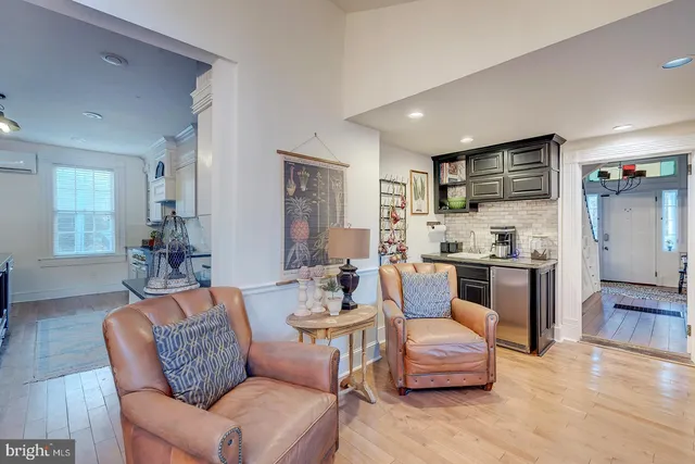 a living room with furniture a chandelier and a chandelier