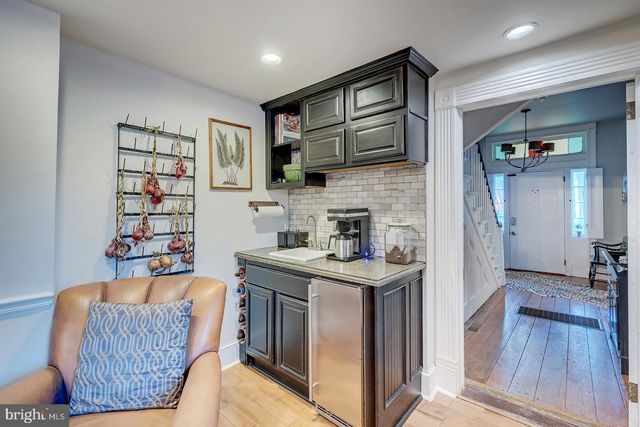 a bed room with a bed a flat screen tv and a chandelier