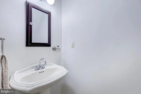 a living room with furniture a flat screen tv and large window
