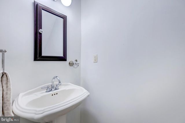 a living room with furniture a flat screen tv and large window