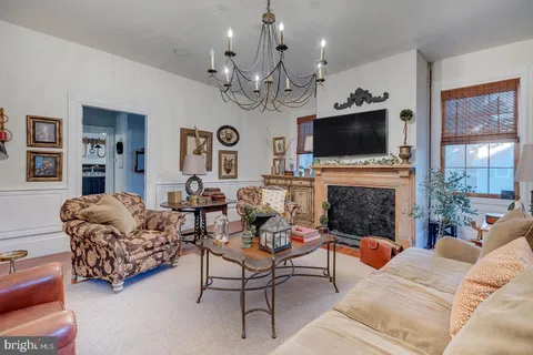 a bedroom with a bed and tv on the dresser