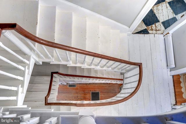 a bathroom with a toilet a sink and a mirror