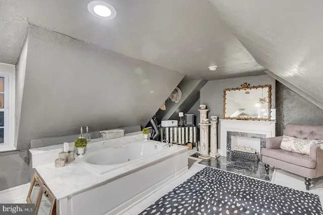 a view of a livingroom with wooden floor and furniture