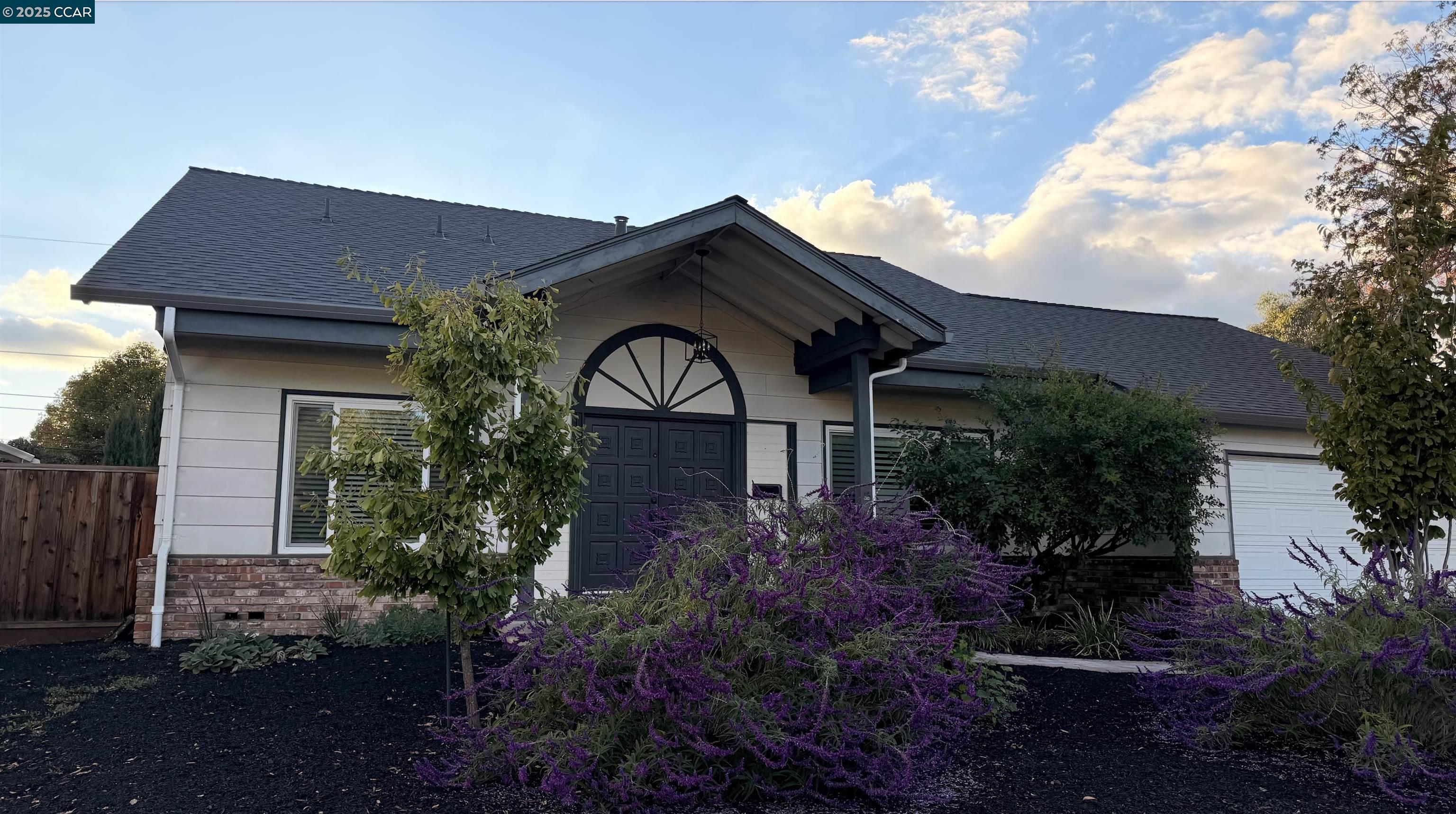 a front view of a house with garden