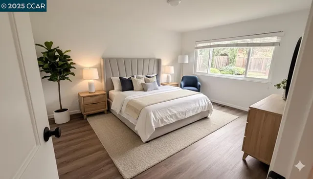 a bedroom with a large bed and a potted plant