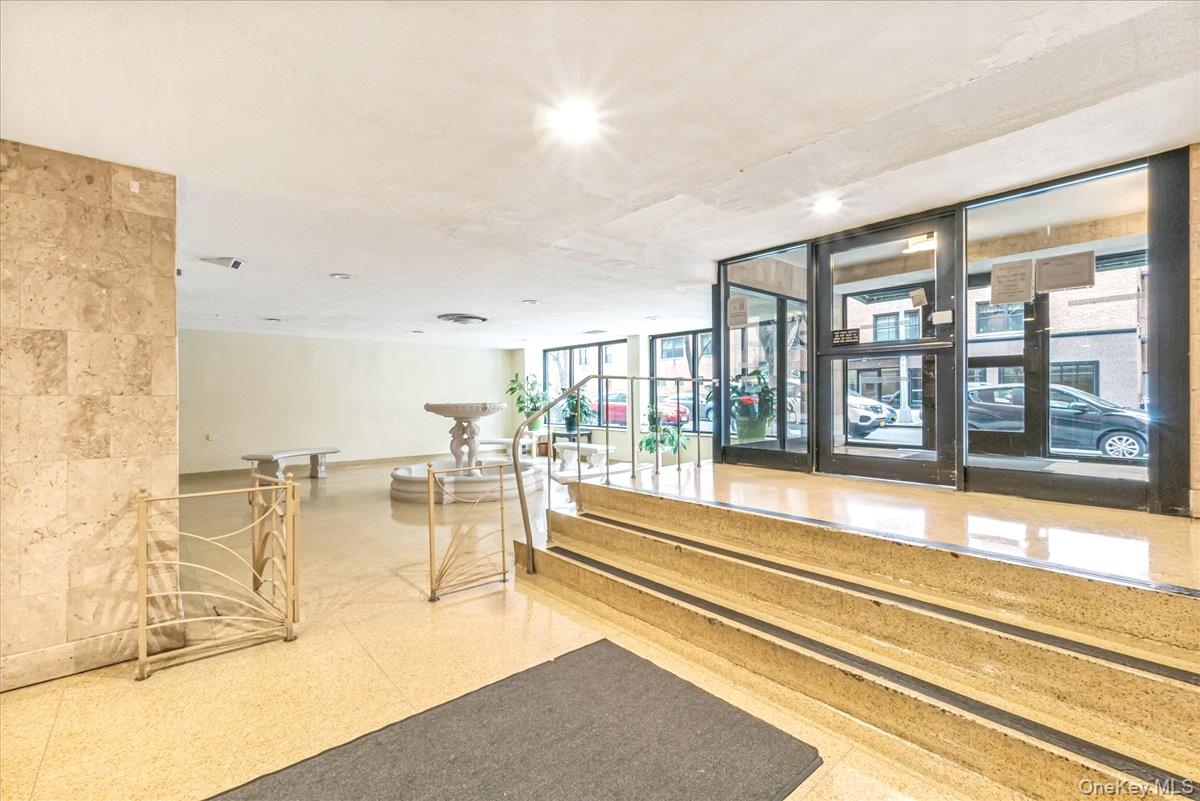 99-35 59th Avenue, Unit L5 Queens, NY 11368 - Photo 14 of 17 Common area featuring expansive windows