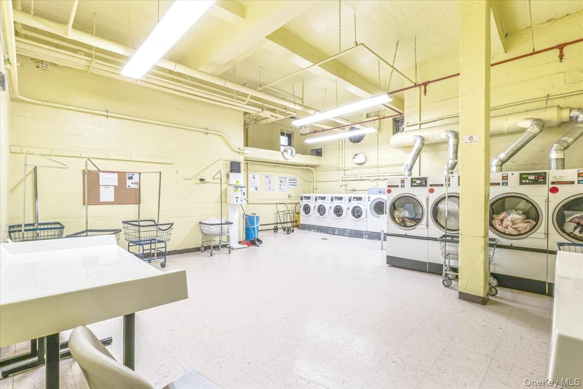 99-35 59th Avenue, Unit L5 Queens, NY 11368 - Photo 15 of 17 Community laundry featuring a towering ceiling and independent washer and dryer