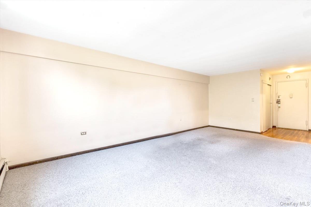 99-35 59th Avenue, Unit L5 Queens, NY 11368 - Photo 6 of 17 Carpeted empty room featuring baseboards