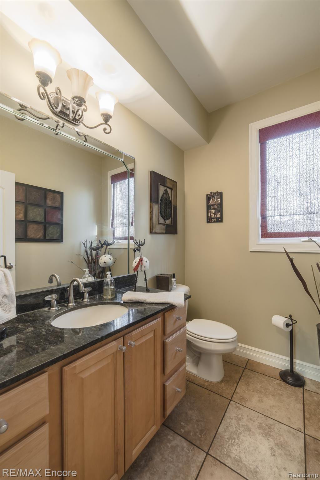 7686 Devins Ridge Clarkston, MI 48348 - Photo 21 of 58 First floor powder room with granite and large vanity