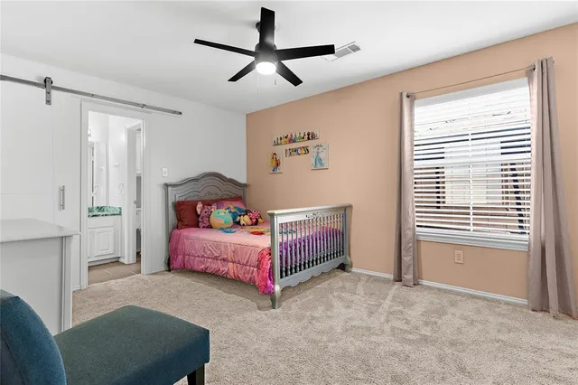 a bedroom with furniture and a window