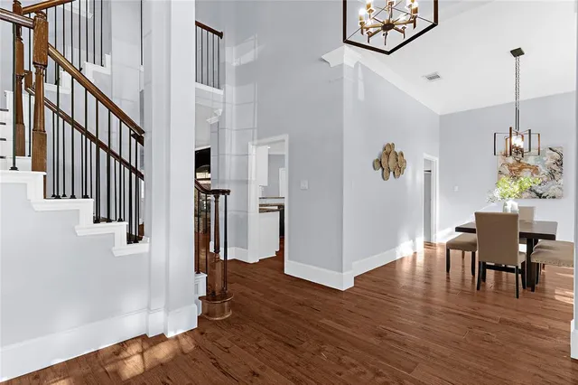 a view of a hallway with wooden floor and entryway