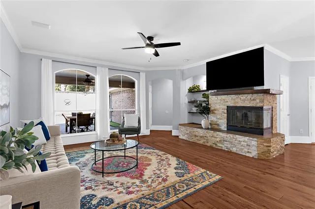 a living room with furniture fireplace and flat screen tv