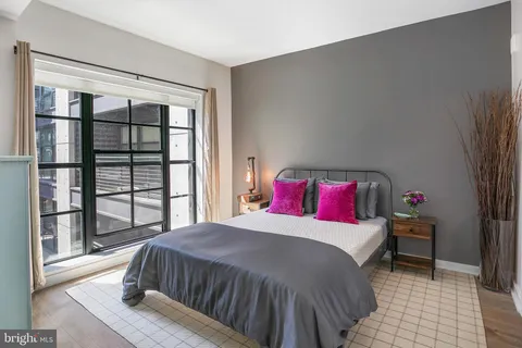 a bedroom with a large bed and a large window